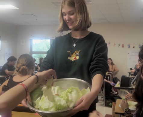 Co-founder Violet Prince hands out lettuce for students to sample. This was the first ever meeting for Lettuce Club, which proved to be a great success. Photo Courtesy of Prahas Kandukuri. 
