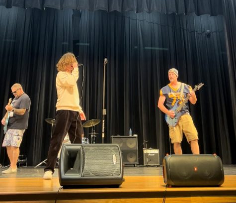  Lights flood the room, the sound of the bass vibrates the ground, the seats are filled with starstruck students. During lunch on October 15, 2022, Steinbrenners auditorium was anything but quiet as the band “Requires Action” took the stage by storm. Photo courtesy of Saule Kondra.