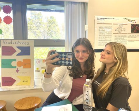 In biology class, freshman Olivia Mariano and Sophie Moye take a photo for BeReal together. When their timer on BeReal went off in class, they thought to take a quick picture before their time was up. Photo courtesy of Brielle Neylan.  