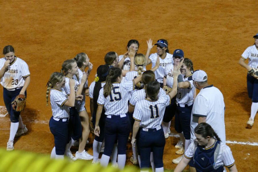 The Lady Warriors celebrate their second win with each other on the field. Steinbrenner parents and supporting students watched from the bleachers as the Steinbrenner pitcher threw the last ball and struck out the Panthers for the win. Photo Courtesy of Alyssa Galang