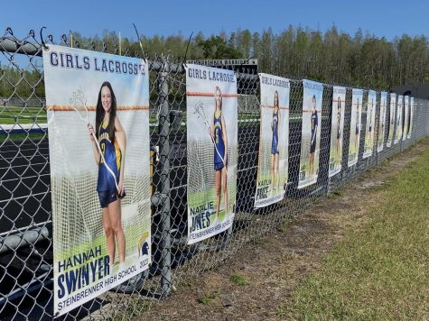 Banners display the class of 2023 seniors for Girls Lacrosse. Of these seniors, 9 are committed to continue their academic and athletic careers in college and they are all hoping to end their high school career with a state championship win. Photo courtesy of Ava Combs. 