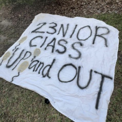 The 2023 senior prank banner lays out to dry before being hung in school. This year, students worked together to create a harmless, fun, and memorable prank. Photo Courtesy of Sophie Payne. 