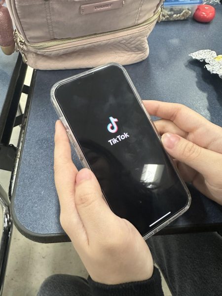 TikTok user, Annika Kaw, opens the popular app to scroll through her For You Page at lunch. In August of 2018, ByteDance turned the nostalgic app of Musical.ly into TikTok which attracted many more users, which led the app to become as popular as it is today. Photo courtesy of Alyssa Galang.  