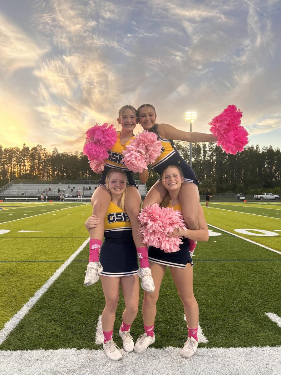 Cheer team celebrates on field during season. They get started in Football season and took themselves all the way to Nationals. Photo courtesy of Cece Hovan. 