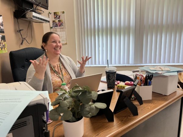 Mrs. Haskell in her element, sharing a moment of laughter while engaging with students in her cozy, personalized classroom. 