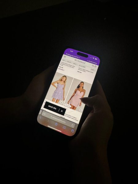 A student scrolling through dress options online to find her homecoming dress. The store Windsor is one of the most popular places to find homecoming attire with a vast array of styles and colors for every person. Photo courtesy of Alyssa Galang. 