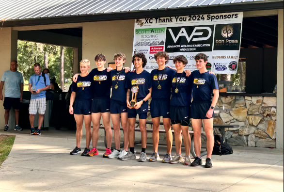 The team stands together after a successful event at Whispering Pines. The team has been working incredibly hard during the summer constantly conditioning and running hundreds of miles collectively. Photo courtesy of Jamin DeWitt. 

 