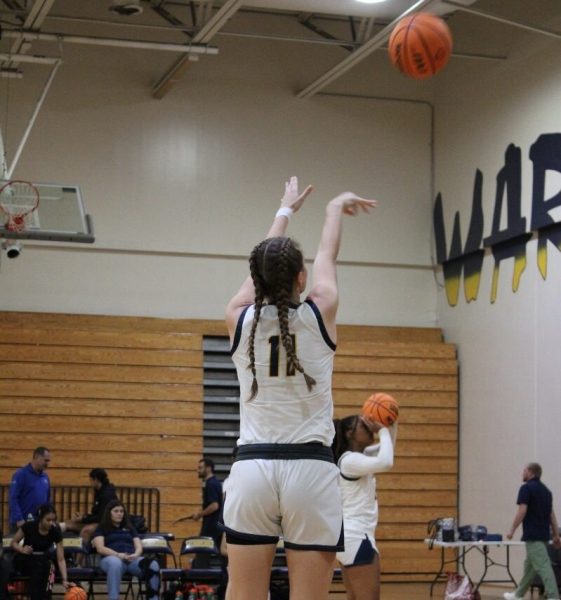 Sophomore Kaylin Ramsey is shooting a 3-point shot in warmups in the game against Alonso. 