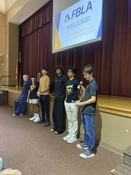 The FBLA leadership introduces a new topic during a club meeting in the auditorium. The student leaders spent a lot of time planning club activities and conferences. Photo courtesy of Allison Cuffaro.