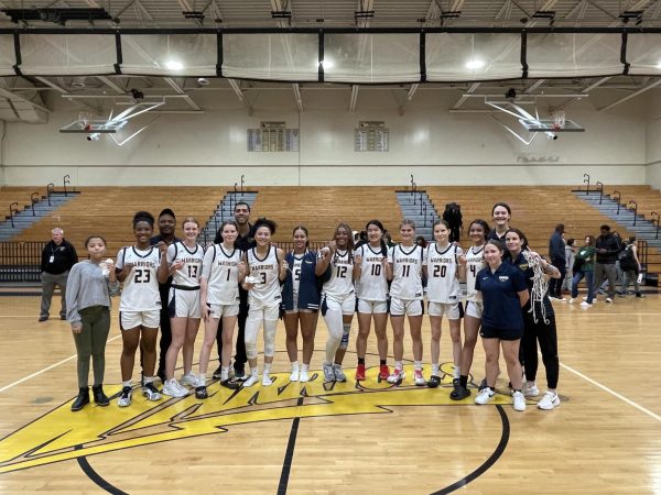 The girl's basketball team just won their regional championship. They are posing for a picture with each of them having a part of the net that they scored on for memory. Photo courtesy Riley Rives .