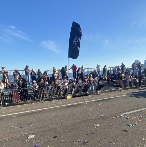 Gasparilla attendees lined up, after the parade floats have passed by and left many beads and trash along the road.  Every piece of trash left behind matters and can negatively impact the environment and wildlife. Photo courtesy of Trey Riley.  