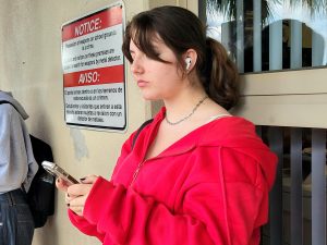 A student at Steinbrenner listening to music through their Air Pods. Users often listen at high volumes which is proven to be a leading cause of hearing damage. Photo courtesy of Weather Riley. 