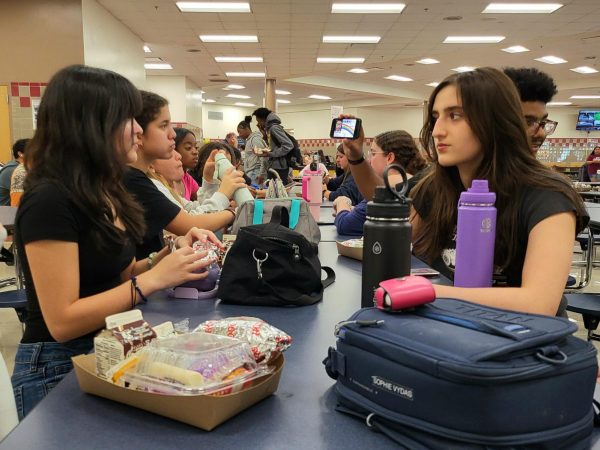 Students in the Steinbrenner cafeteria conversing over lunch served by the school. Steinbrenner has been serving warm meals to students since 2009. Photo courtesy of Weather Riley. 