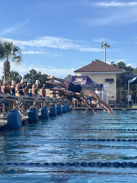 Swimmers take their mark and launch into the race. A snapshot of precision, training, and competition in motion. This swim meet was held at academy’s pool. Photo courtesy of Lily Gorgol.