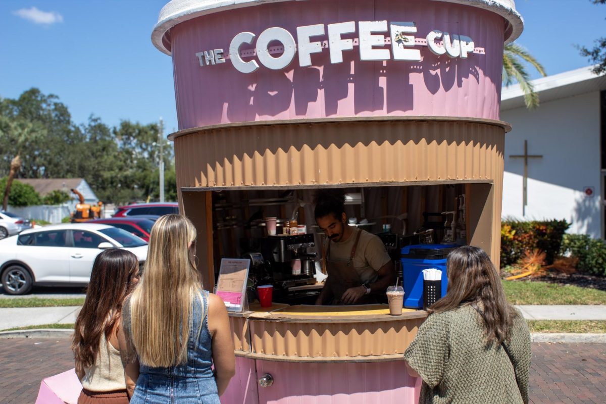 The Big Coffee Cup Cafe serves customers outside House of Petals, Safety Harbour. The Big Coffee Cup Cafe’s iconic cart was built by Amr Sharaki, the owner. Photo courtesy of Shirin Kohli.  