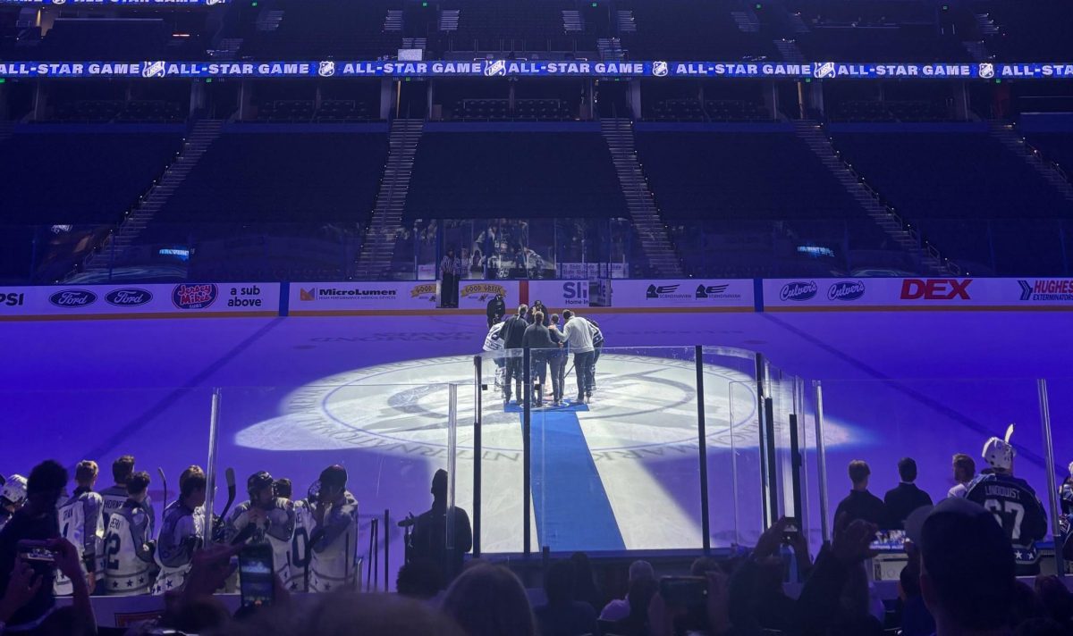 Lightning Alumni prepare to start the All-Stars game with a ceremonial puck drop. For hockey fans, the puck drop was a fun addition to the All-Stars game as it resembles the professional NHL games. Photo courtesy of Zach Conner. 