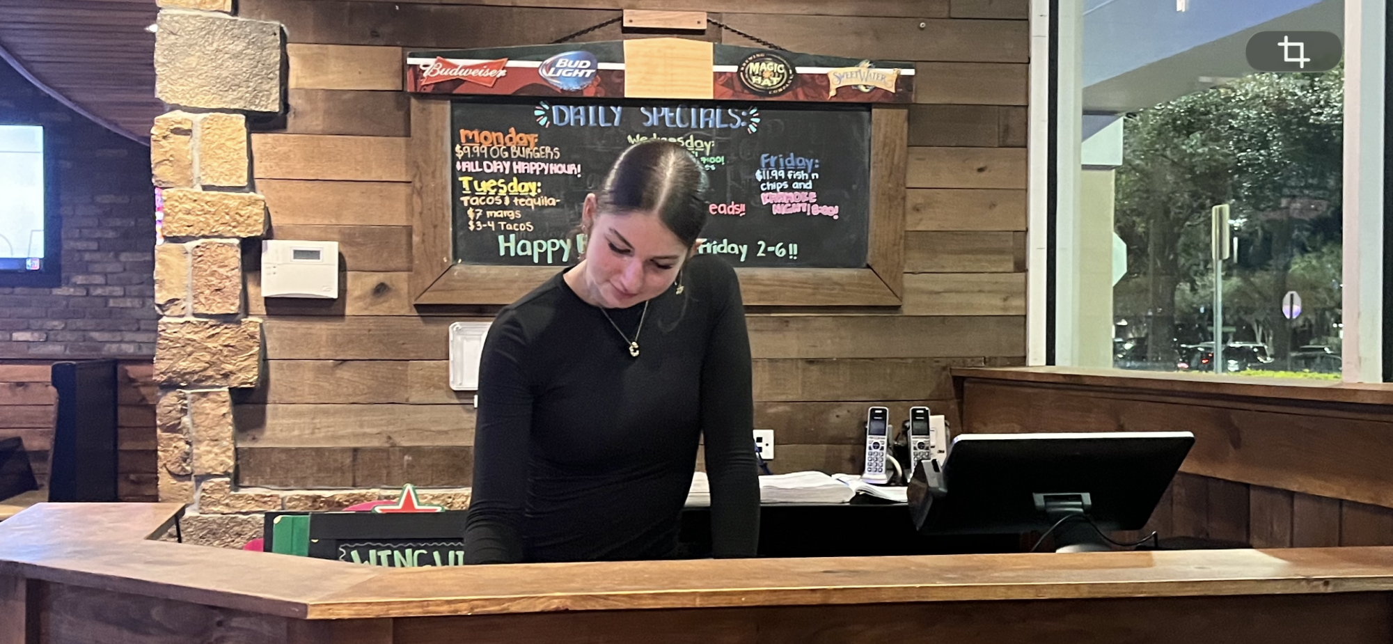 Carissa Curry being a hostess at the Stonewater Tavern. Once she got her job, she focused on her balance between work hours and her education. Photo courtesy of Renee Bornowski.